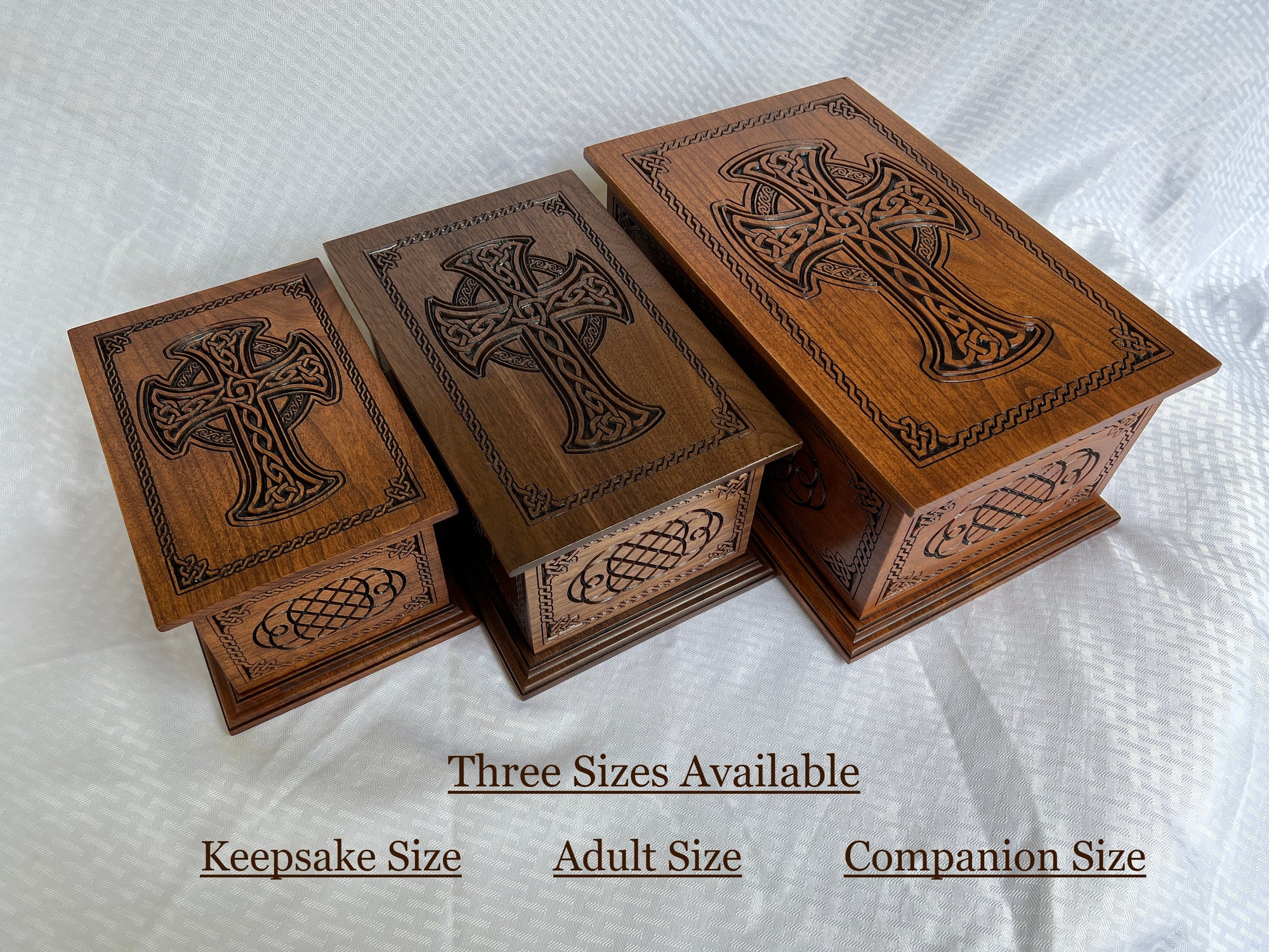 Image shows the approximate difference in the three available sizes offered in the Celtic Cross and Weave Urn between the keepsake size (intended for a portion of an average adult's cremated ashes), adult size, and companion size (designed for two adult humans cremation ashes)