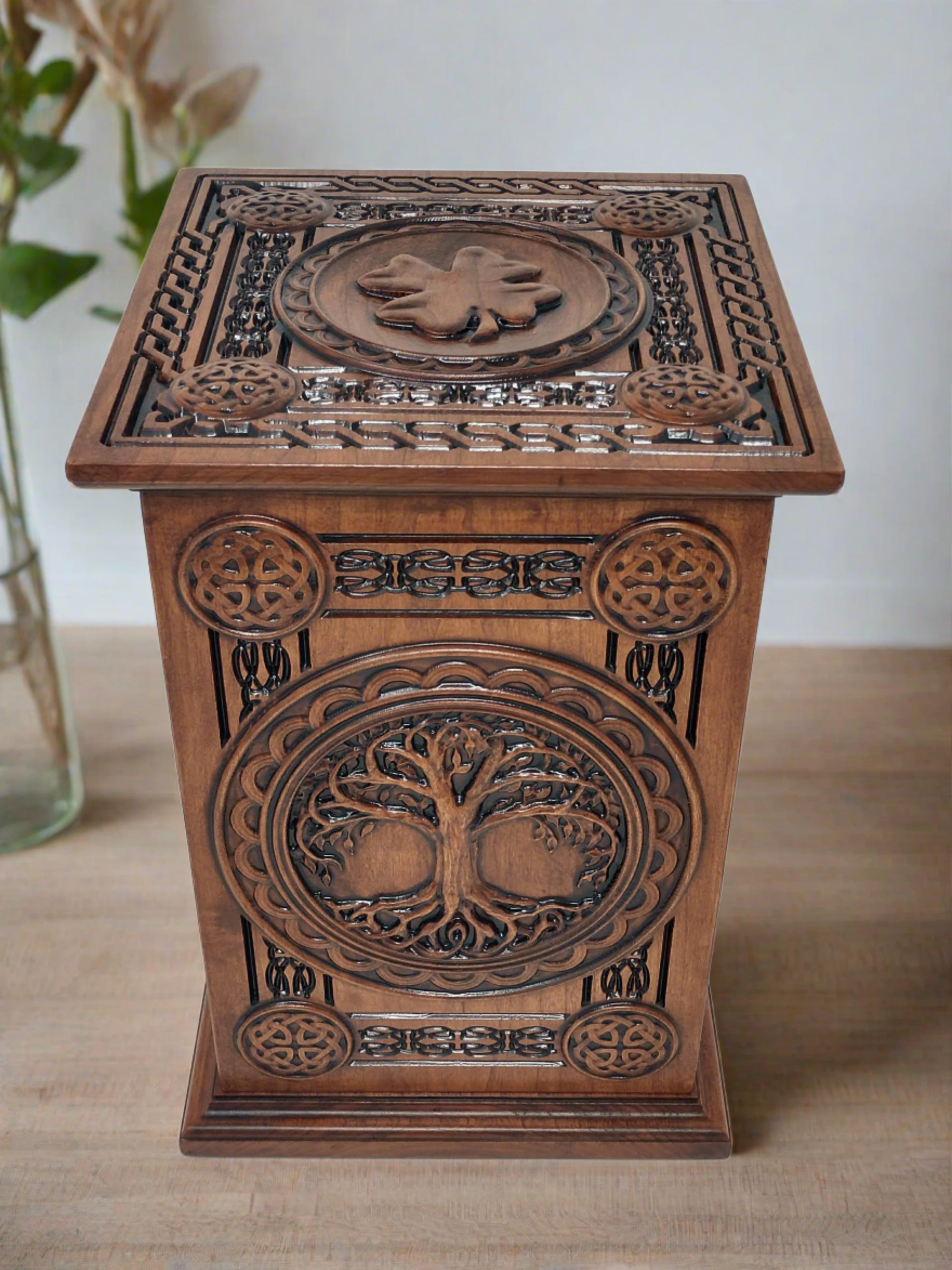 Celtic Tree of Life Urn carved with Tree of Life on front with ornate Celtic carvings around. The top of the urns for cremation ashes is the carving of a shamrock and more Celtic knot boarders and accents.