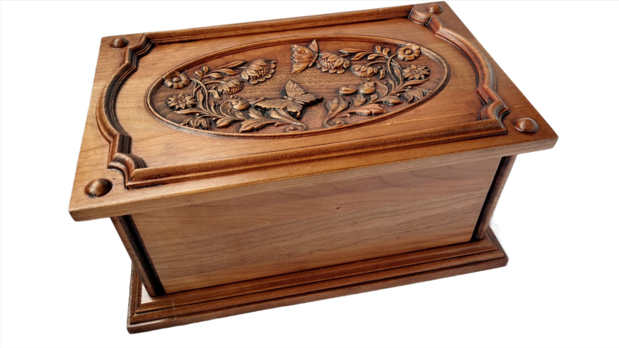 Image captures the butterfly and flower urn at an angled view. This is urn is made for the cremated ashes of an adult human.