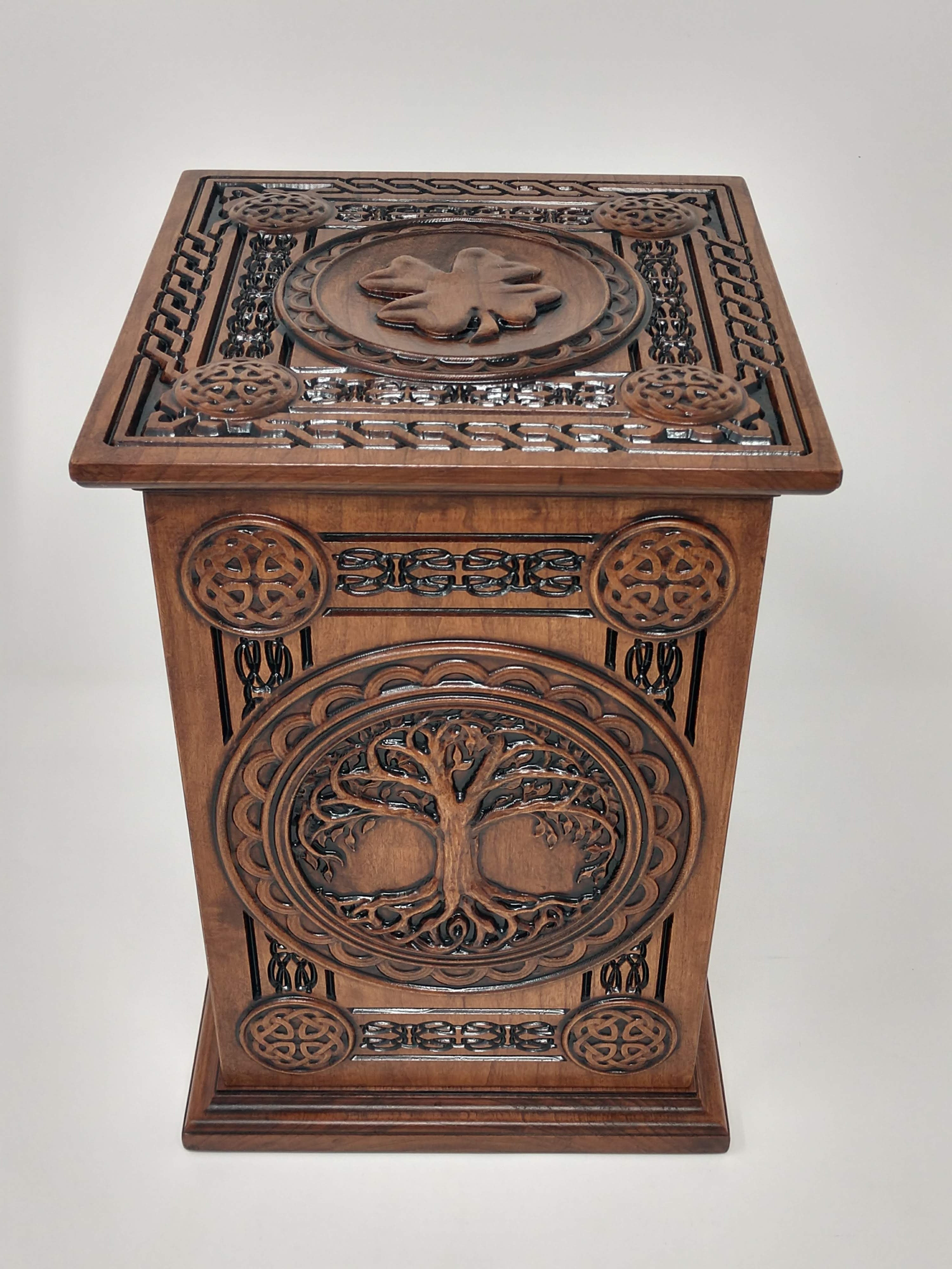 Celtic Tree of Life Urn carved with Tree of Life on front with ornate Celtic carvings around. The top of the urns for cremation ashes is the carving of a shamrock and more Celtic knot boarders and accents.